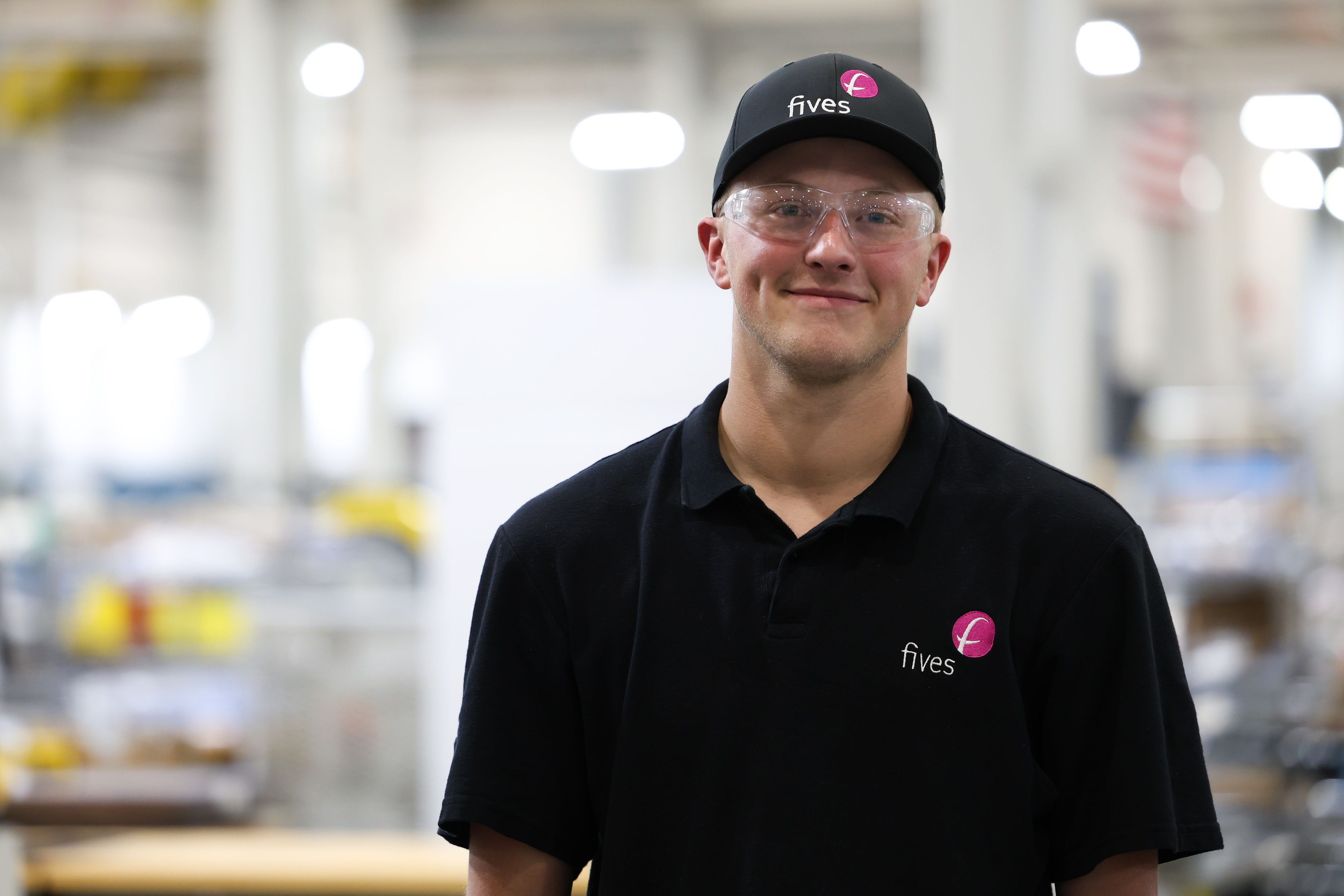 Fives technician wearing safety glasses in an industrial workshop