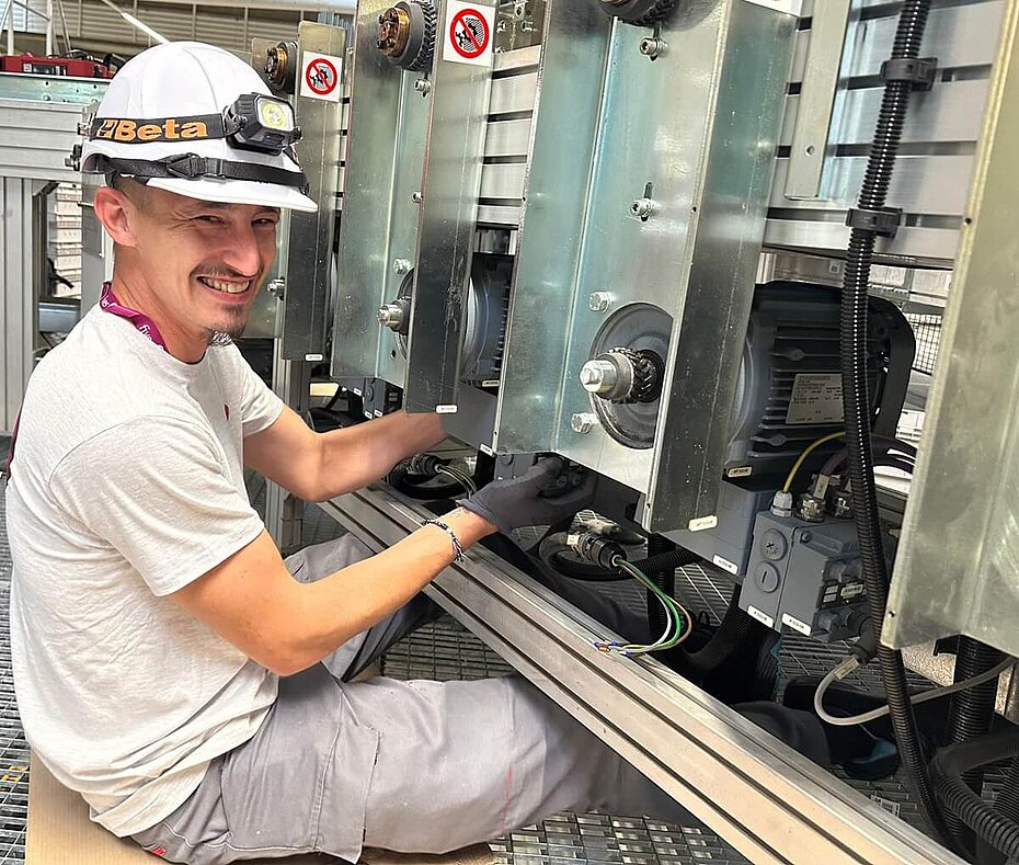 Fives' service technician working on a conveyor